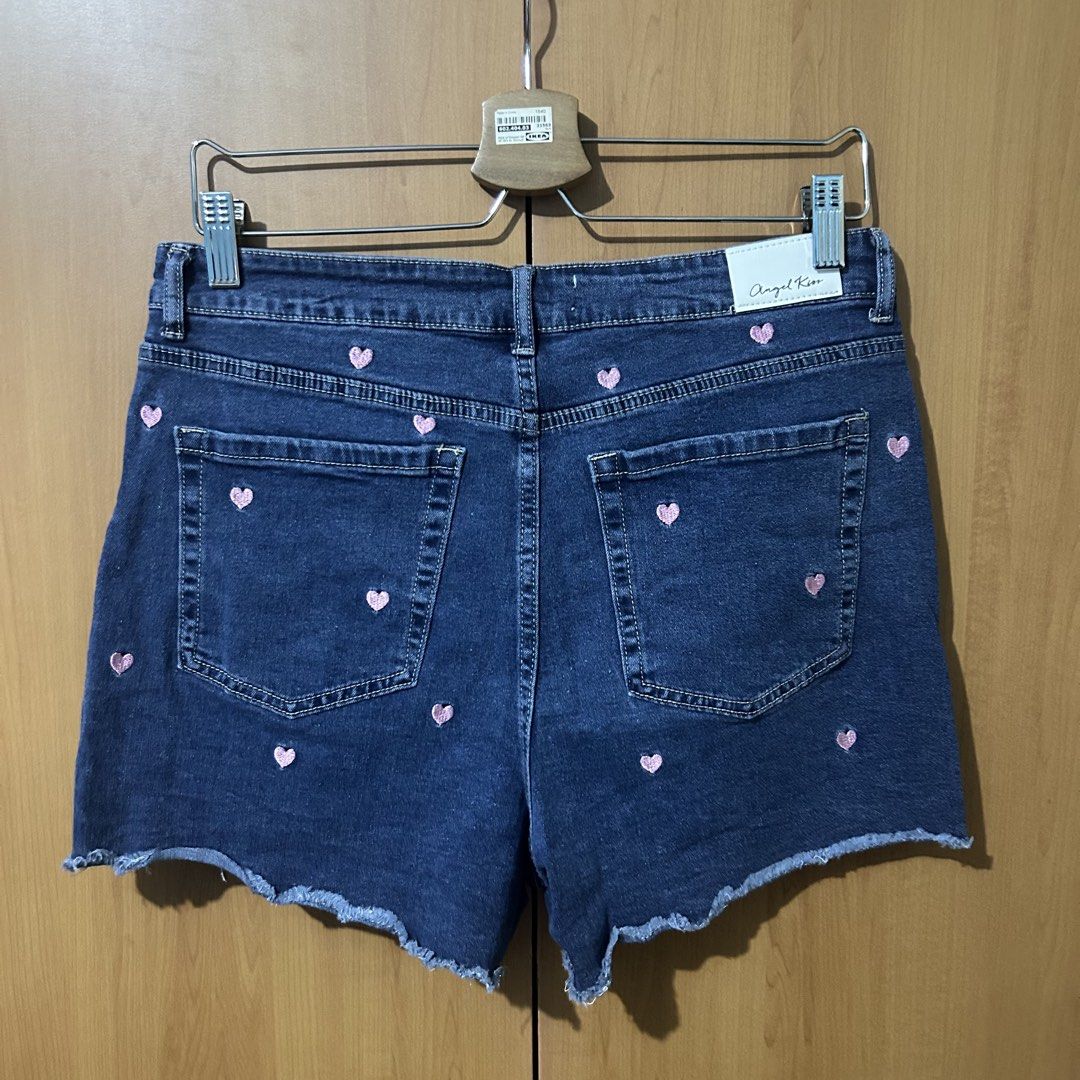 Big Size Dark Denim Shorts (Category: Shorts) located in Mandaluyong City. Submitted by vwonu (Listing ID 1469860877, Image 3). Description: - Waist: 33-36 -Brand: Angel Kiss - Color: Dark blue denim with tiny pink embroidered hearts all over - Fit: Mid-rise with a trendy raw hem - Design: Classic five-pocket style with button and zipper closure - Style: Cute streetwear, perfect for casual days out.