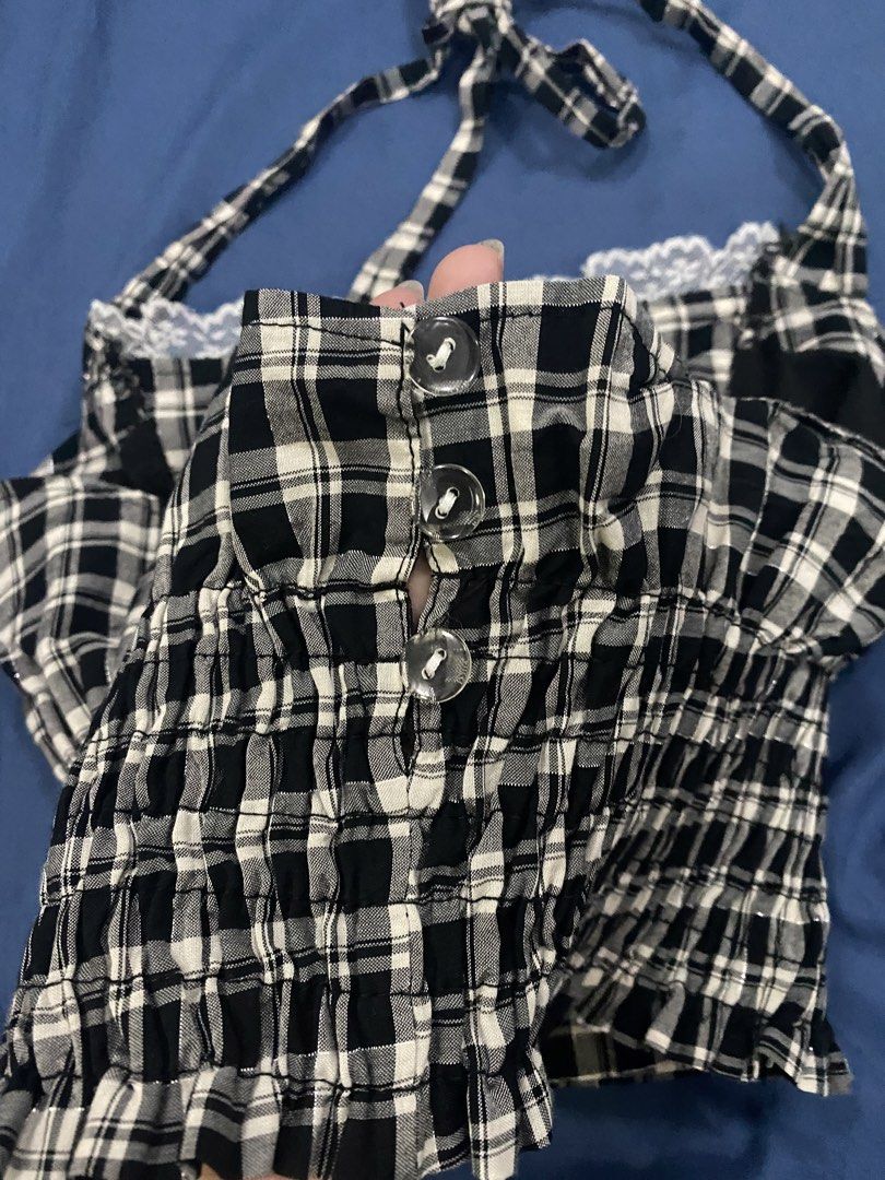 Black and White Plaid Halter Crop Top Size S (Category: Sleeveless) located in Manila. Submitted by escherichiaa (Listing ID 1469803896, Image 2). Description: - Color/Pattern: Black and white plaid - Size: S (tag attached) - Design: Halter neck, lace-trimmed sweetheart neckline, decorative front buttons - Fit: Smocked and stretchy body - Fabric: Lightweight, ideal for warm weather - Styling: Perfect to pair with high-waisted denim shorts or skir