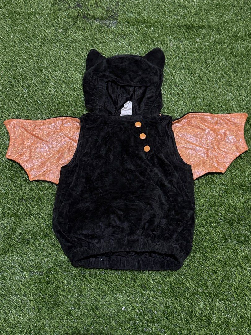 Black bat hoodie costume (Category: Babies & Kids Fashion) located in San Fernando. Submitted by InvisibleMe (Listing ID 1469814529, Image 1). Description: - Adorable black fuzzy bat hoodie with plush material all over - Features sparkly orange wings attached to the sides - Hood comes with cute sewn-on bat ears - Three stylish orange buttons at the front neck area - Comfortable elastic band around the bottom hem - Ideal for Halloween, costume par
