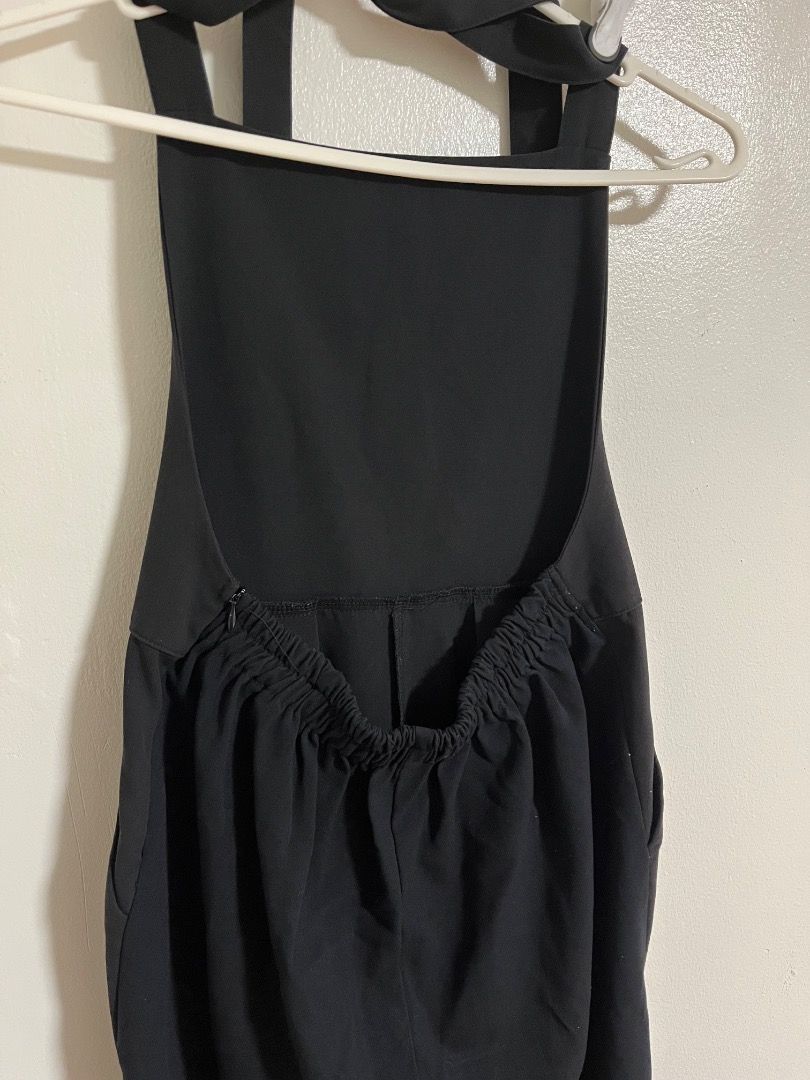Black Halter Neck Jumpsuit with Back Zipper (Category: Jumpsuits) located in Cabuyao City. Submitted by rdtrmt (Listing ID 1469868526, Image 3). Description: - Color: Solid black - Style: Sleeveless, minimalist jumpsuit - Neckline & Straps: Square front neckline with thick halter straps - Fit & Closure: Elasticated back waistband and convenient side zipper - Cut: Cropped pant length with a straight-leg cut - Fabric: Lightweight and comfortable.