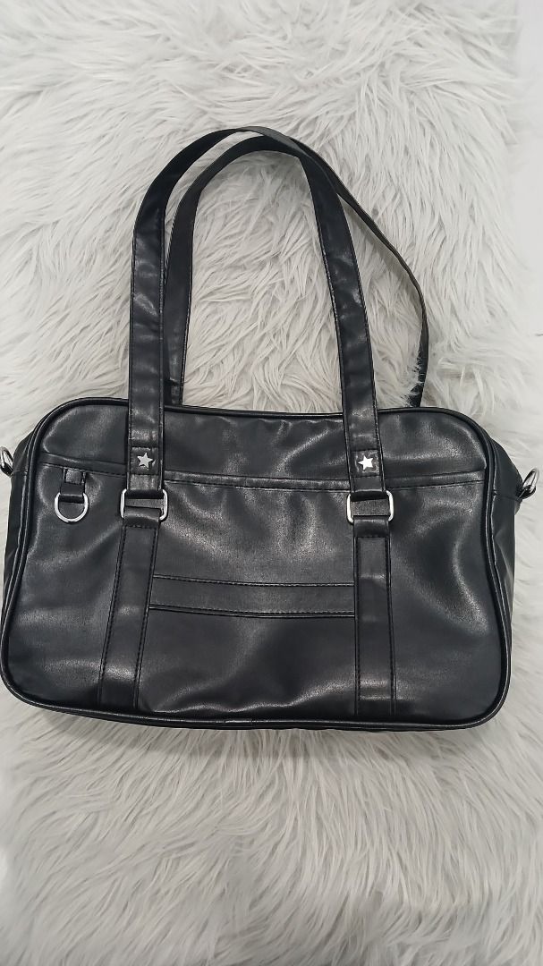 Black Japanese Student Style Shoulder Bag (Category: Shoulder Bags) located in Pasig City. Submitted by chinTM (Listing ID 1469803264, Image 1). Description: - Style: Everyday structured shoulder bag - Material: Water-resistant synthetic PU leather with a fabric lining - Handles: Double top tote handles - Details: Silver star studs and front D-ring hardware - Design: Rectangular shape with clean front pocket stitching - No flaws.