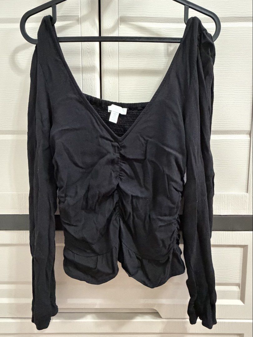 Black Long Sleeve Smocked Ruffle Blouse (Category: Blouses) located in Valenzuela. Submitted by johnbenerramos (Listing ID 1469869975, Image 1). Description: - Color: Black - Neckline: Square neck - Details: Smocked elastic front panel for a flattering fit, cute ruffle trims along sides and hem - Sleeves: Long sleeves with a slightly relaxed fit - Fabric: Soft, lightweight, and comfortable - Styling: Perfect to pair with high-waisted jeans or ski