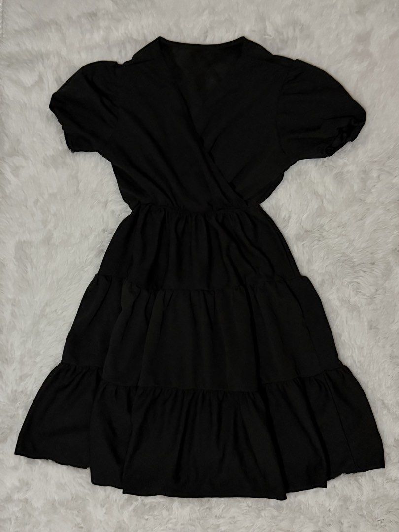 Black Puff-Sleeve Tiered Wrap Dress (Category: Dresses) located in Batangas. Submitted by claverialyka (Listing ID 1469846049, Image 2). Description: Color: Black Style: Wrap Dress Sleeves: Short Puff Sleeves Neckline: V-Neck Waist: Elastic Waist Skirt Design: Tiered with Gathered Details Length: Midi or Maxi (depending on how it falls when worn) Fit: Cinched Waist with Flared Skirt.
