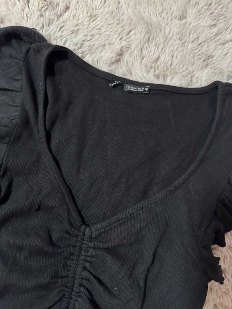 Black Ruched Crop Top with Ruffle Sleeves (Category: Sleeveless) located in Calamba. Submitted by cheriiv (Listing ID 1469895127, Image 2). Description: - Style: Black ribbed crop top with short ruffle sleeves - Details: Scoop neckline with front drawstring ruching and adjustable tie at the bottom hem - Material: Stretchy, comfortable cotton blend - Size: S (Tag on collar).