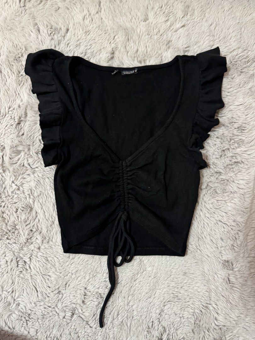 Black Ruched Crop Top with Ruffle Sleeves (Category: Sleeveless) located in Calamba. Submitted by cheriiv (Listing ID 1469895127, Image 1). Description: - Style: Black ribbed crop top with short ruffle sleeves - Details: Scoop neckline with front drawstring ruching and adjustable tie at the bottom hem - Material: Stretchy, comfortable cotton blend - Size: S (Tag on collar).