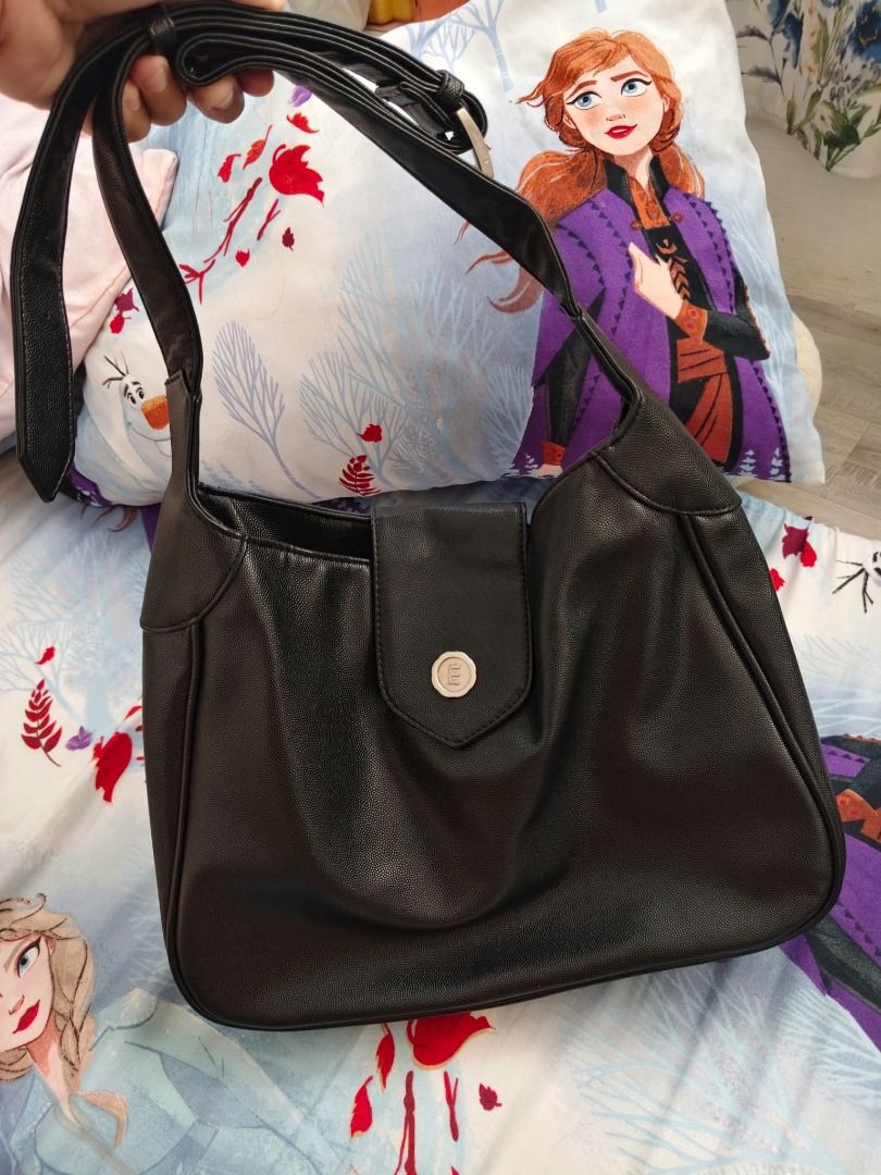 Black shoulder bag with adjustable strap (Category: Shoulder Bags) located in Caloocan City. Submitted by alodiaveni09874 (Listing ID 1469947249, Image 1). Description: - Color: Classic Black - Material: Premium faux leather - Closure: Secure flap with stylish silver metallic buckle - Strap: Long and fully adjustable for comfort - Interior: Spacious main compartment for daily essentials - Condition: Brand new - Perfect for work, school, or casual