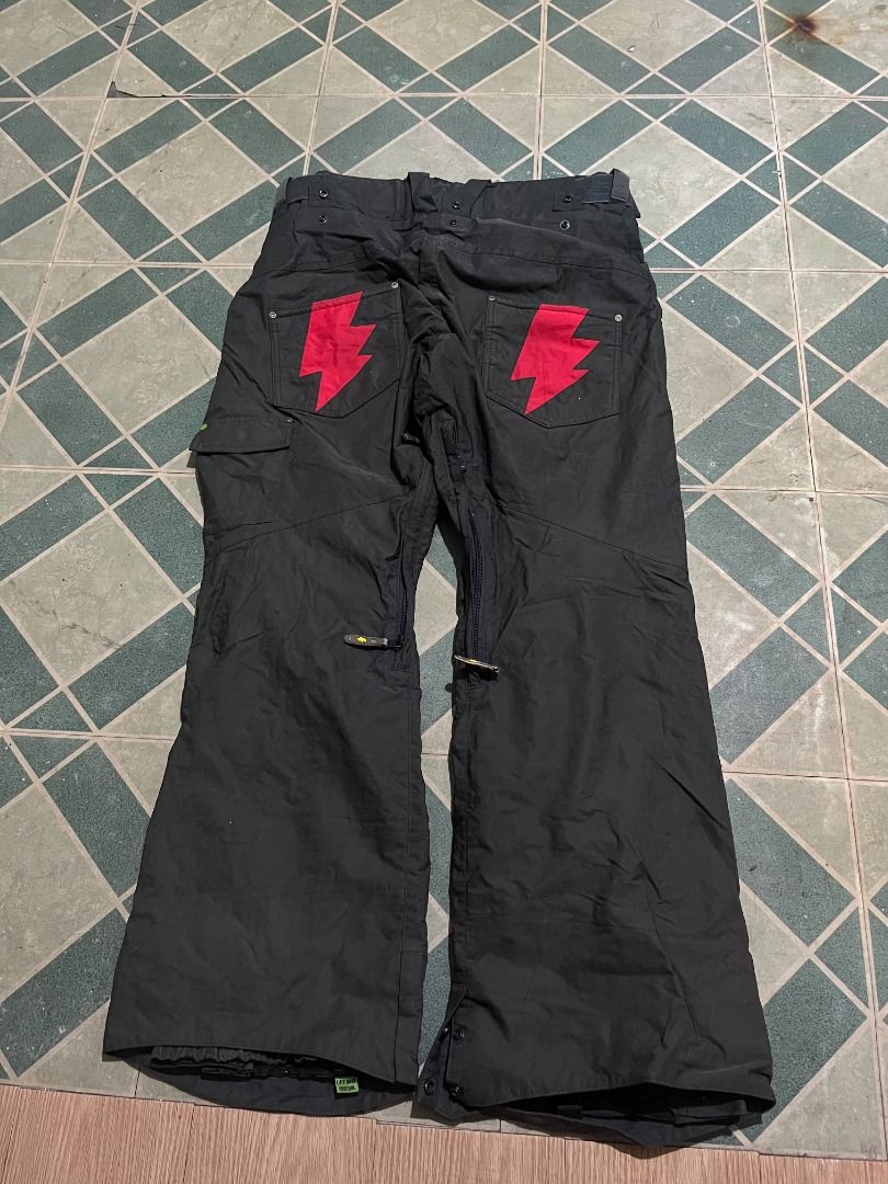 Black Snowboard Pants with Red Lightning Bolts (Category: Jeans) located in Pateros City. Submitted by m4ry.b0o (Listing ID 1469822298, Image 1). Description: - Color: Black with bright red lightning bolt patches on back pockets - Fit: Wide leg with adjustable waist setup - Features: Functional zip details down the legs - Material: Heavy-duty, built for winter weather and the slopes - Condition: Brand new / Excellent (ready to wear).