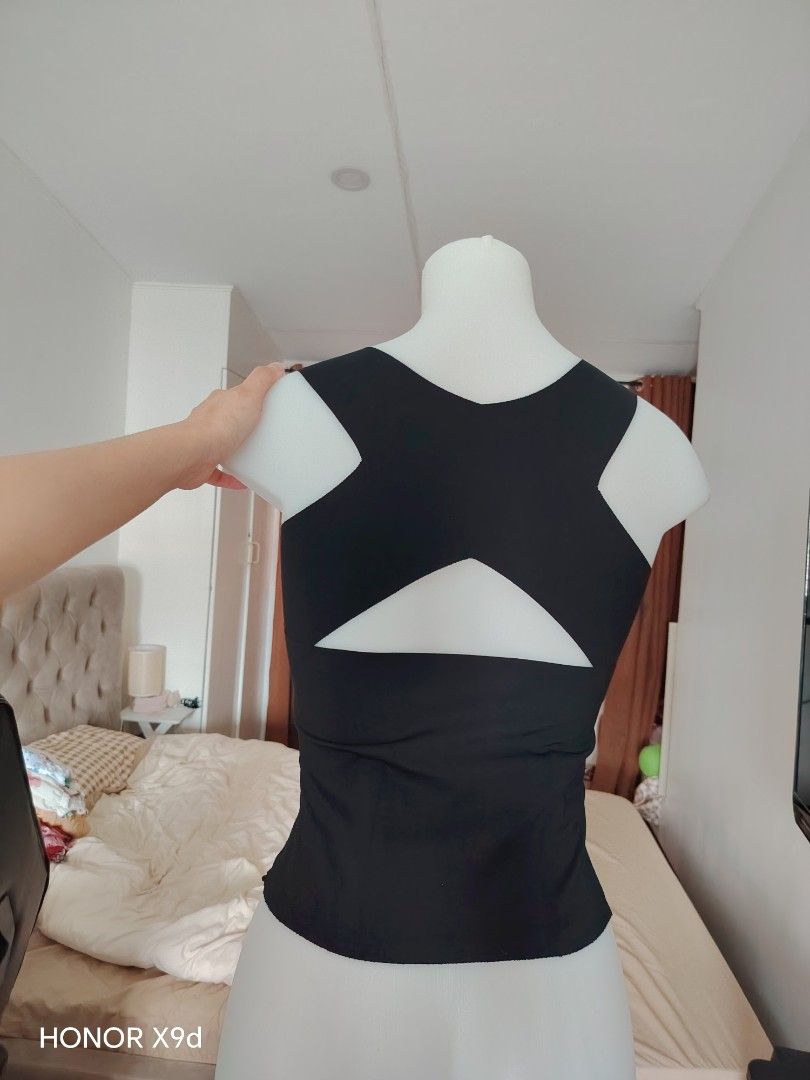 Black tank top with cutout back design (Category: Sleeveless) located in Mabalacat. Submitted by Jackikay.PreLoved (Listing ID 1469846263, Image 2). Description: - Color: Classic Black - Design: Sleeveless with square neckline and wide straps with 2 boning - Back Detail: Stylish geometric cutout - Fit: Form-fitting with comfortable, stretchy fabric - Length: Hits right at the hip area.