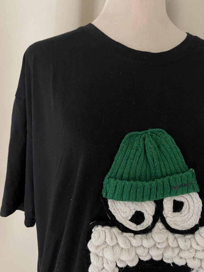 Black TEE with 3D Textured Cartoon (Category: Shirts) located in Cainta. Submitted by zlove111 (Listing ID 1469769809, Image 3). Description: Black t-shirt featuring a funny cartoon character appliqué on the front. Includes a knitted green beanie, big swirling eyes, textured white beard, and black mouth detail. Short sleeves, crew neckline, relaxed fit. Made from comfortable cotton material. Fun streetwear piece. cotton oversize up to xxl 24" .