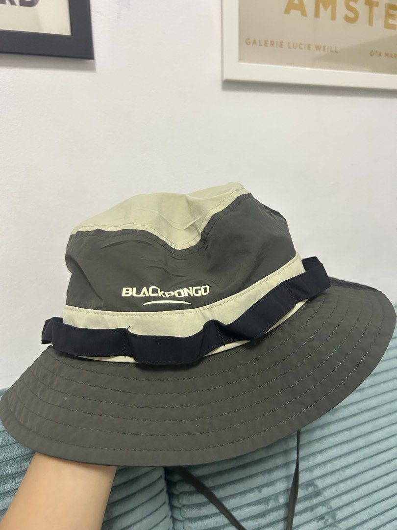 Blackpongo Two-Tone Bucket Hat (Category: Caps & Hats) located in Cavite. Submitted by _schmyla (Listing ID 1469888015, Image 1). Description: - Brand: Blackpongo - Color: Khaki and dark grey panels with a contrasting black strap - Features: Adjustable chin cord for windy days, inner sweatband - Condition: Tag intact - Ideal for: Hiking, camping, and daily casual wear.