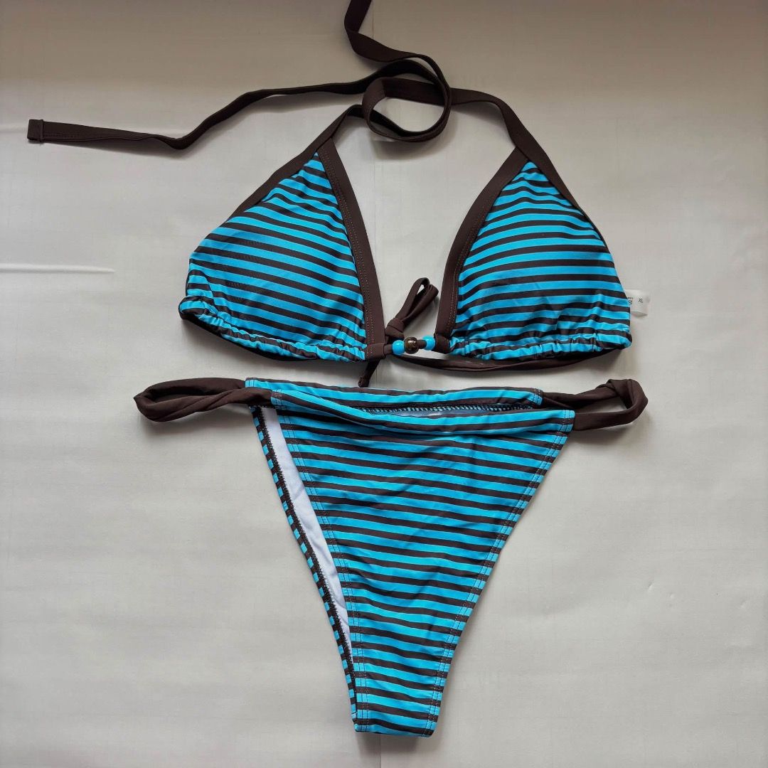 Blue and brown striped two piece bikini set (Category: Bikinis & Swimsuits) located in Taguig. Submitted by imeverywhereimsellahhhh (Listing ID 1469821365, Image 1). Description: - Condition: Brand new with tags (never worn) - Design: Blue and black striped two-piece bikini with stylish brown trim - Top: Triangle halter style with adjustable neck and back ties for a custom fit - Bottoms: Low-rise cut with trendy side strap details - Material: Sof