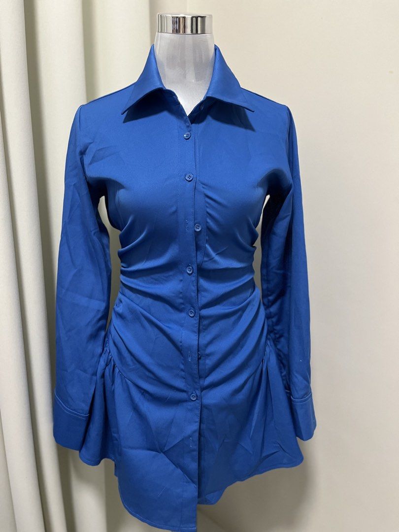 Blue Button Up Dress with Lace Up Back (Category: Dresses) located in Angeles City. Submitted by pinkpool (Listing ID 1469771447, Image 1). Description: Vibrant royal blue shirt dress featuring a fitted ruched bodice, lace-up corset back, and a flared skater hem. Made from a smooth, slightly stretchy fabric with long sleeves and a pointed collar. Perfect for a chic, standout look!.