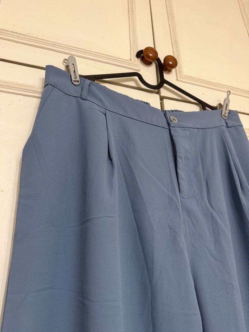 Blue High-Waisted Wide-Leg Trousers (Category: Jeans) located in Rizal. Submitted by rianaht (Listing ID 1469932409, Image 2). Description: - Waist: 17 inches - Length: 40 inches - Color: Dusty blue - Cut: Wide leg with chic pleated front details - Closure: Front button with a comfortable back elastic waistband - Material: Soft and lightweight, perfect for all-day wear - Versatility: Ideal for both casual daily outfits and office wear - Condition