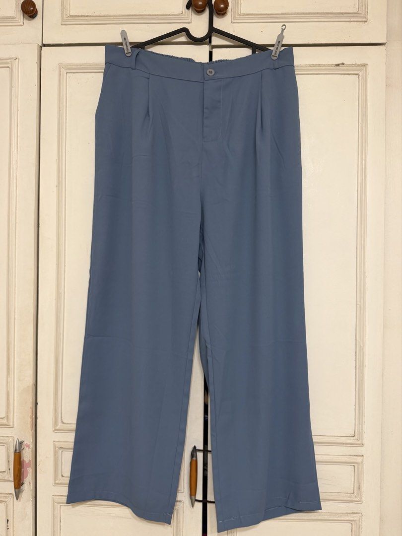 Blue High-Waisted Wide-Leg Trousers (Category: Jeans) located in Rizal. Submitted by rianaht (Listing ID 1469932409, Image 1). Description: - Waist: 17 inches - Length: 40 inches - Color: Dusty blue - Cut: Wide leg with chic pleated front details - Closure: Front button with a comfortable back elastic waistband - Material: Soft and lightweight, perfect for all-day wear - Versatility: Ideal for both casual daily outfits and office wear - Condition