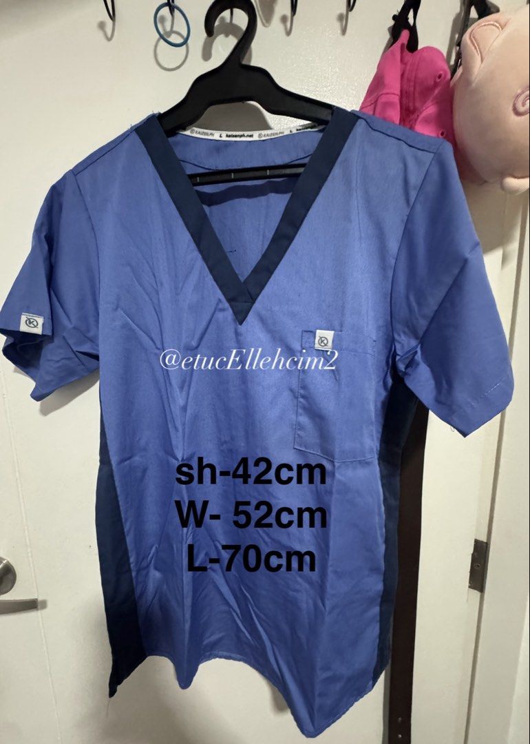 Blue Medical Scrub Top Size L (Category: Activewear) located in Pasay City. Submitted by michmonteros (Listing ID 1469871467, Image 1). Description: - Brand: KaizenPH - Item: Medical scrub top - Color: Blue with dark blue V-neck trim and side panels - Size: L - Details: Chest pocket with logo tag, branded tag on right sleeve - Measurements (laid flat): Shoulder 42cm, Width 52cm, Length 70cm - Condition: Clean and ready to wear.