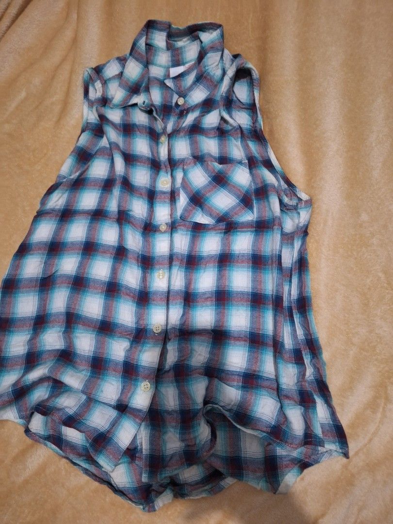 Bongo Plaid Sleeveless Button-Up Shirt Medium (Category: Sleeveless) located in Paranaque City. Submitted by ellech16 (Listing ID 1469836134, Image 1). Description: - Brand: Bongo - Style: Sleeveless button-up shirt with classic collar - Pattern: Blue, white, and maroon plaid - Details: Single chest pocket on the left side - Material: Lightweight cotton-blend - Size: Medium (M) - Origin: Made in Bangladesh.
