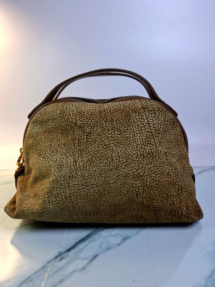 Borbonese Redwall Handbag Brown Patented Italian Designer (Category: Luxury Bags & Wallets) located in Pasay City. Submitted by onick_79 (Listing ID 1469929144, Image 1). Description: Crafted in Italy by Redwall, this dome mini Boston bag features Borbonese’s iconic Occhio di Pernice (quail eye) textured suede paired with classic brown genuine leather trim and polished gold hardware. A timeless, chic piece that seamlessly blends vintage luxury wi