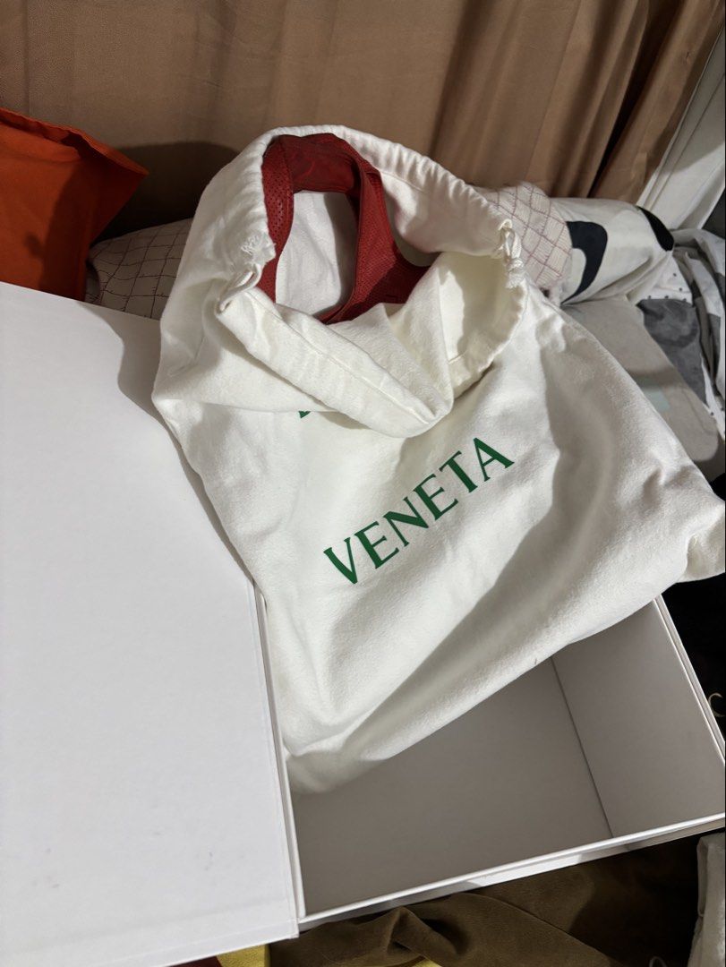 Bottega Veneta (Category: Tote Bags) located in Caloocan City. Submitted by rossvault2 (Listing ID 1469871833, Image 3). Description: - Brand: authentic Bottega Veneta - Style: Red perforated leather tote bag with subtle woven leather square pattern - Handles: Double shoulder handles - Interior: Fabric lining with zip pocket - Origin: Made in Italy - Inclusions: Original white box, dust bag, care cards, and receipt paperwork - Condition: Guarante