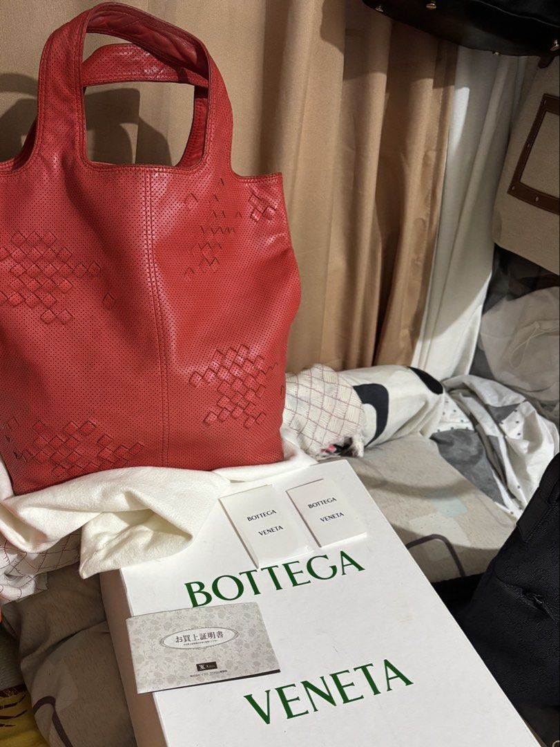 Bottega Veneta (Category: Tote Bags) located in Caloocan City. Submitted by rossvault2 (Listing ID 1469871833, Image 1). Description: - Brand: authentic Bottega Veneta - Style: Red perforated leather tote bag with subtle woven leather square pattern - Handles: Double shoulder handles - Interior: Fabric lining with zip pocket - Origin: Made in Italy - Inclusions: Original white box, dust bag, care cards, and receipt paperwork - Condition: Guarante