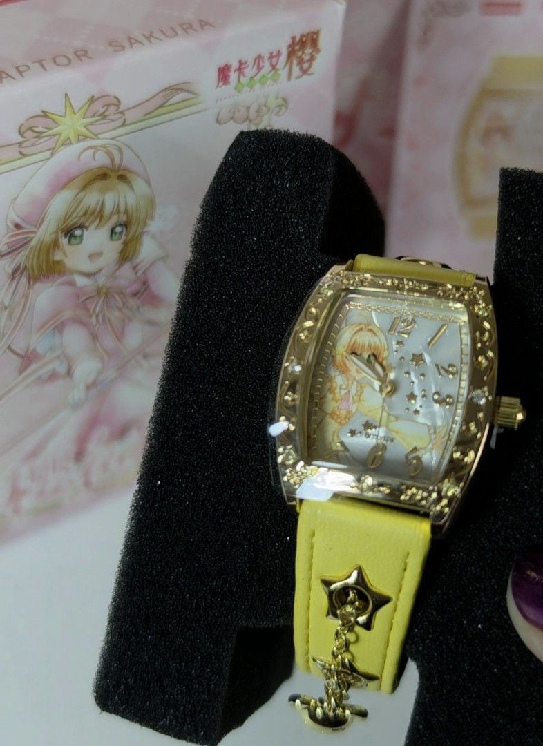 BOXFUN Cardcaptor Sakura Yellow Watch (Category: Women's Watches) located in Pasig City. Submitted by ccsakura4 (Listing ID 1469913580, Image 1). Description: - Brand: Boxfun (Model 02 - Cardcaptor Sakura edition) - Case: Gold-tone rectangular case with a sparkly bezel - Dial: Mother-of-pearl dial featuring a Sakura illustration and crystal star hour markers - Strap: Yellow leather strap with star cutouts, dangling star charm, and Kero-chan charm