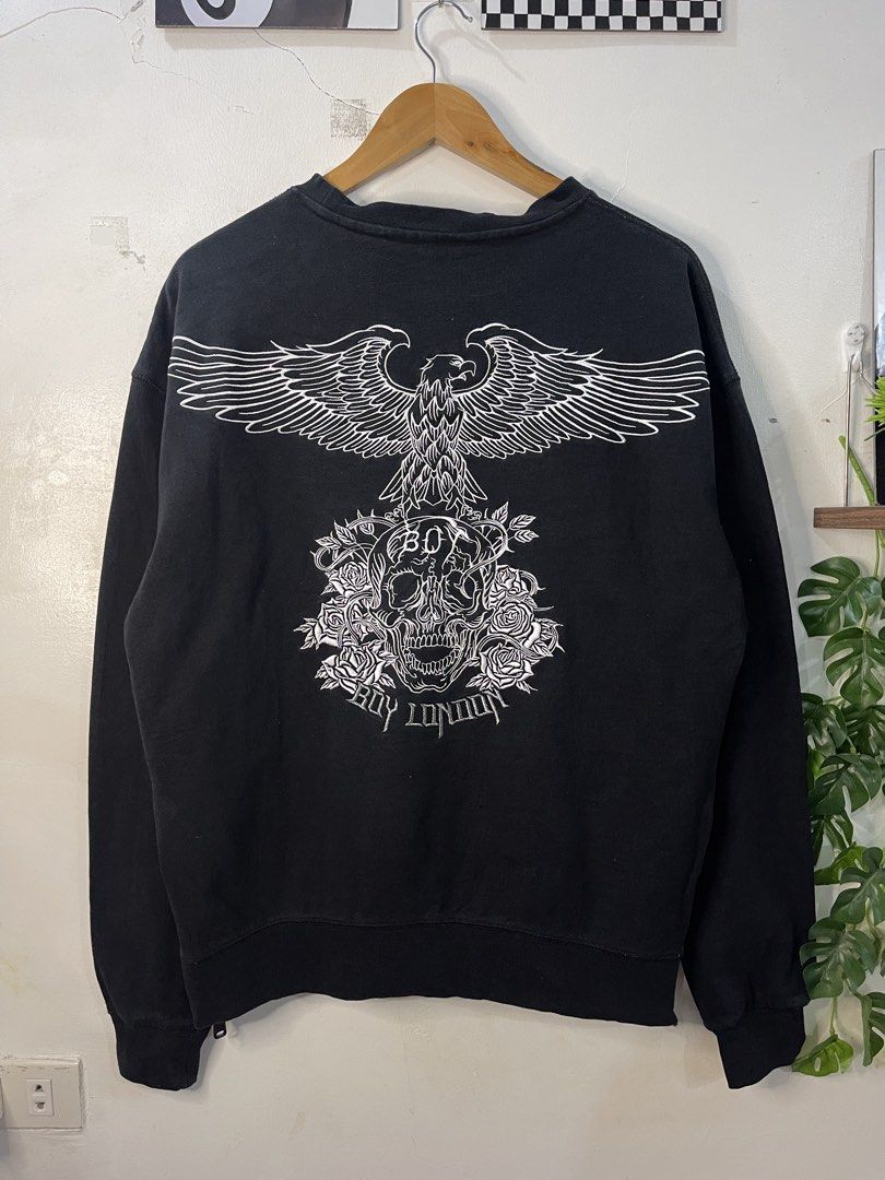 Boy London Black Eagle Skull Sweatshirt (Category: Coats, Jackets and Outerwear) located in Cabagan. Submitted by blessingma81004 (Listing ID 1469766347, Image 2). Description: - Brand: Boy London - Color: Black with metallic silver chest logo and large white eagle/skull back graphic - Size: Fits Medium to Large (Width: 22.5 inches, Length: 26.5 inches) - Condition: 9.5/10 (Minimal loose neck, otherwise excellent) - Features: Trendy side zippers 