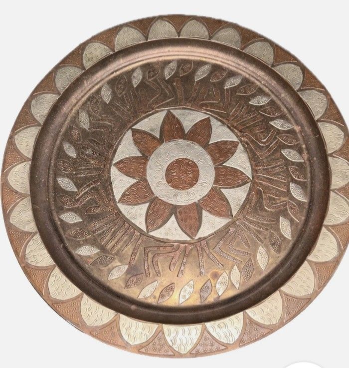 Brass and copper wall decor.. (Category: Vintage Collectibles) located in Manila. Submitted by quickpenguin.f18608 (Listing ID 1469760289, Image 1). Description: a vintage Middle Eastern or North African (such as Moroccan or Cairo-ware) decorative brass and copper wall plate or serving tray featuring an embossed central floral/star motif and geometric design..