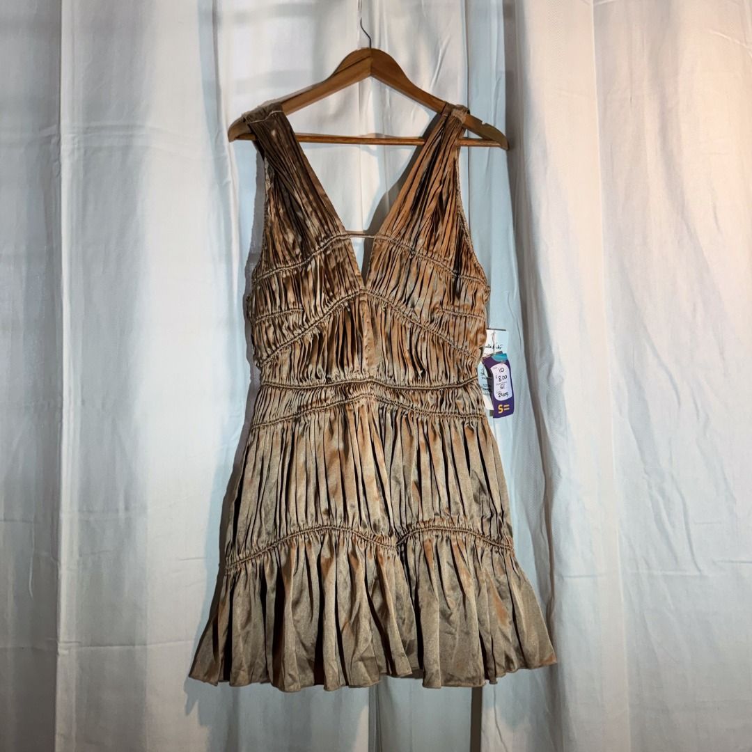 Bronze Dress (Category: Dresses) located in Marikina City. Submitted by repurpose_studio (Listing ID 1469794094, Image 1). Description: - Item: Bronze satin runched mini dress - Condition: Brand new with original tags, never worn - Size: 10 (Sample) - Design: Deep V-neckline with front strap accent, sleeveless - Details: Trendy tiered ruffled skirt - Perfect for: Parties, nights out, and special occasions RFS: Aspiring a minimalist lifestyle .