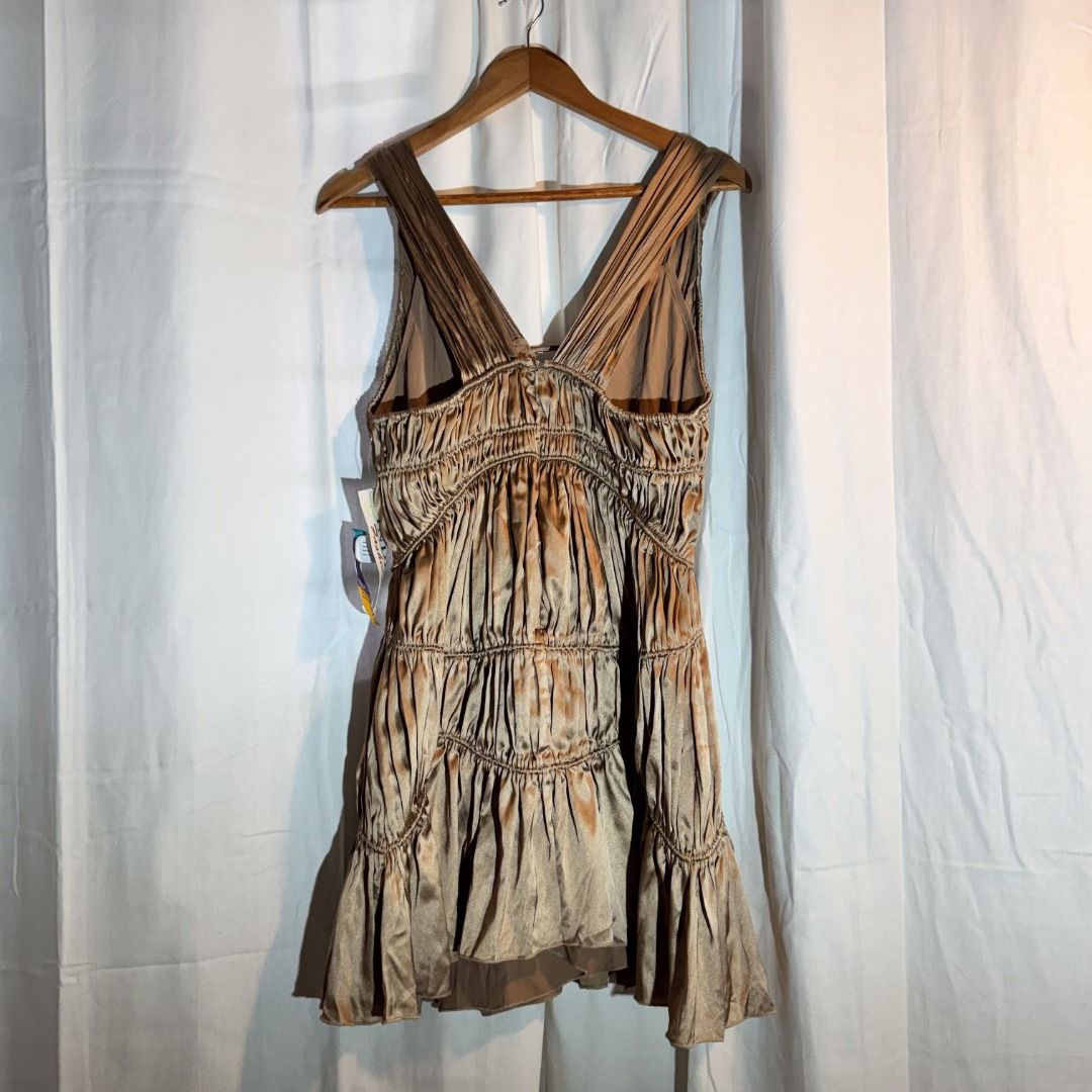 Bronze Dress (Category: Dresses) located in Marikina City. Submitted by repurpose_studio (Listing ID 1469794094, Image 3). Description: - Item: Bronze satin runched mini dress - Condition: Brand new with original tags, never worn - Size: 10 (Sample) - Design: Deep V-neckline with front strap accent, sleeveless - Details: Trendy tiered ruffled skirt - Perfect for: Parties, nights out, and special occasions RFS: Aspiring a minimalist lifestyle .