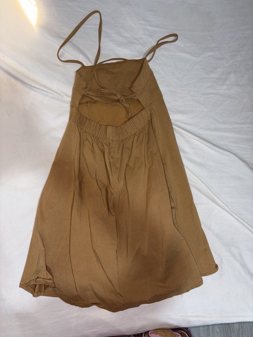 Brown cami mini dress with open back (Category: Dresses) located in Makati City. Submitted by art_angel (Listing ID 1469789988, Image 2). Description: - Color: Khaki - Style: Mini skater dress with a flared skirt and simple hem - Neckline & Straps: Square neckline with thin spaghetti straps - Back Details: Trendy thin criss-cross tie straps - Fit: Comfortable elasticated waistline - Fabric: Smooth and lightweight, perfect for warm weather - Condi