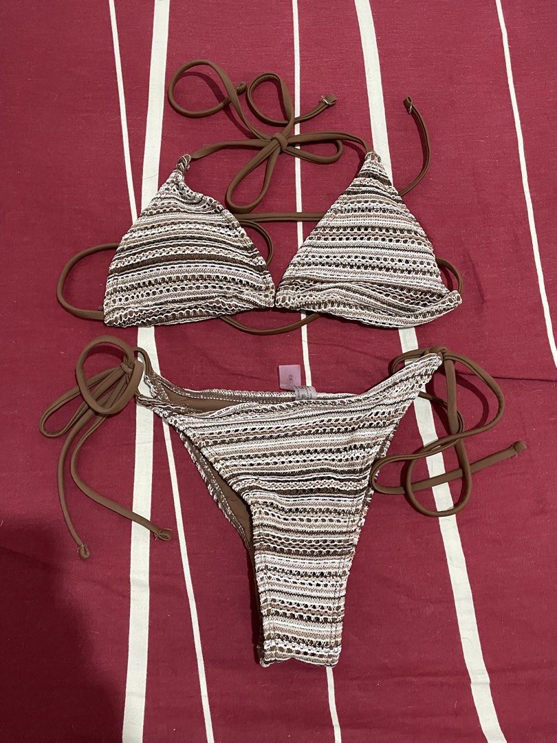 Brown Crochet Triangle Bikini Set with Side Ties (Category: Bikinis & Swimsuits) located in Manila. Submitted by quickturtle_b8d593 (Listing ID 1469828651, Image 1). Description: - Brown and white striped crochet bikini set - Triangle top with halter neck ties and adjustable back strap - Matching bottoms with side tie closures for a customizable fit - Beautiful knit fabric pattern throughout - Brand tag attached on the bottom piece.