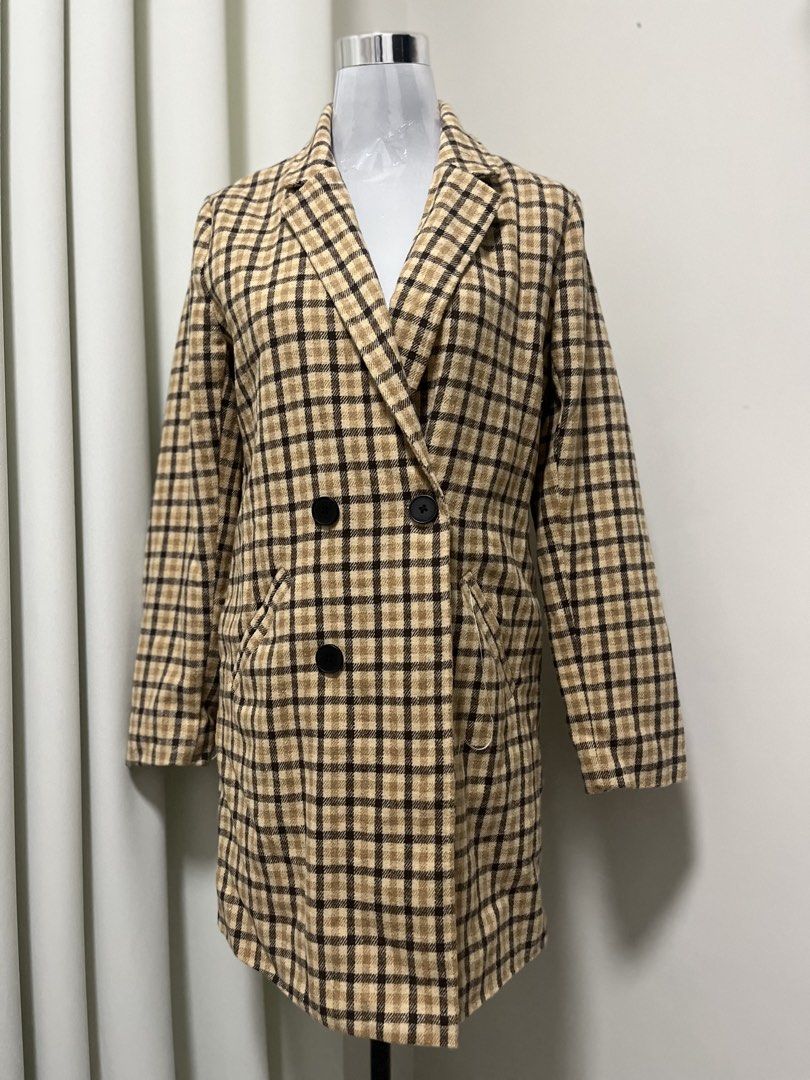 Brown Plaid Double-Breasted Trench Coat (Category: Coats, Jackets and Outerwear) located in Angeles City. Submitted by pinkpool (Listing ID 1469765458, Image 1). Description: - Classic brown and beige plaid trench coat - Thick, flannel-like fabric ideal for cooler weather - Double-breasted button front with traditional lapel collar - Structured shoulders and flattering mid-length cut - Equipped with two functional slanted front pockets.