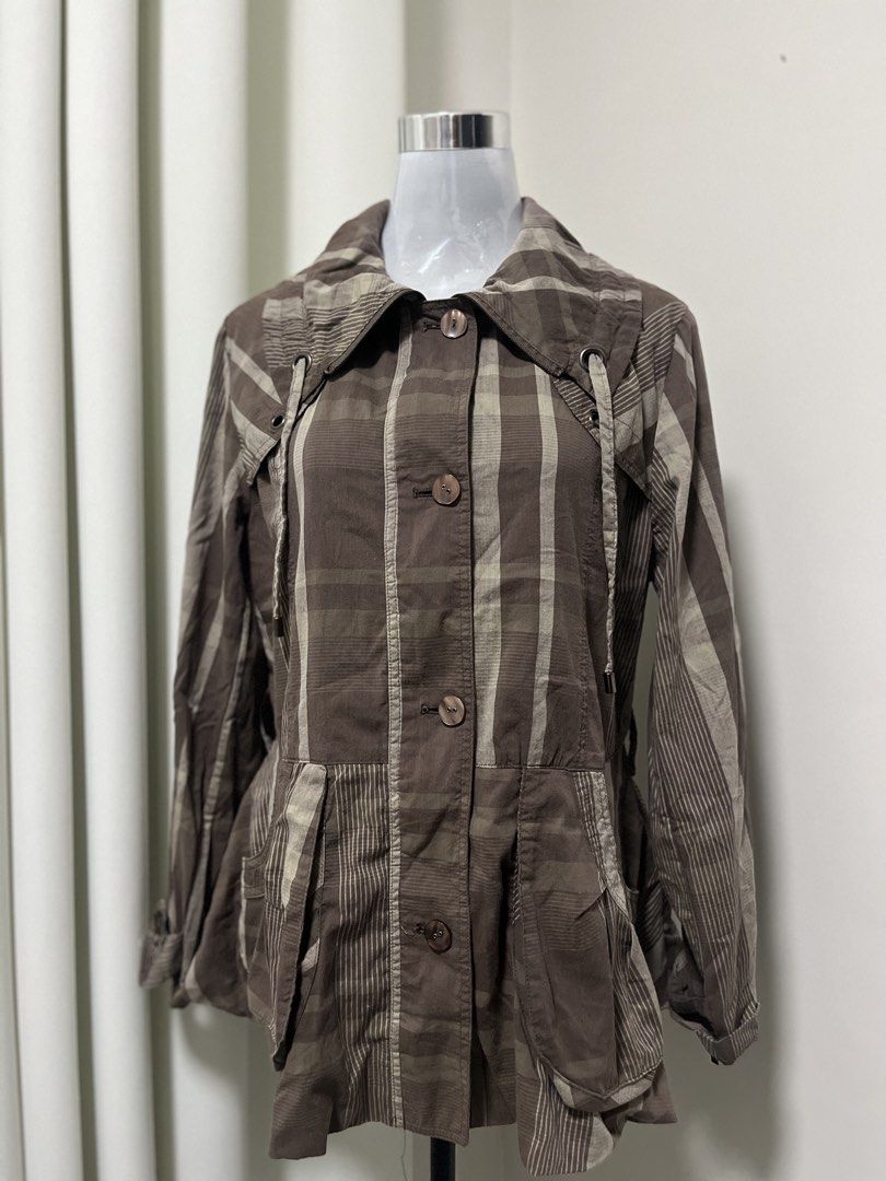 Brown Plaid Patterned Button-Up Jacket with Drawstrings (Category: Coats, Jackets and Outerwear) located in Angeles City. Submitted by pinkpool (Listing ID 1469764834, Image 1). Description: - Brown and beige plaid jacket with mixed stripe panels - Features a classic collar and front button-up closure - Adjustable drawstrings near the chest area - Two convenient front pockets near the hem - Lightweight fabric in stylish earthy tones.