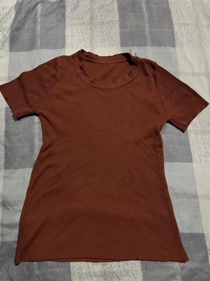 Brown ribbed short sleeve t-shirt (Category: Shirts) located in Legazpi City. Submitted by chynnunez (Listing ID 1469876828, Image 1). Description: - Color: Brown - Style: Short sleeve crewneck tee with a fitted cut - Material: Stretchy cotton-blend fabric with a ribbed knit texture - Condition: Clean, simple design with no major flaws - Versatility: Perfect basic for everyday outfits or layering, easy to match with jeans or skirts.
