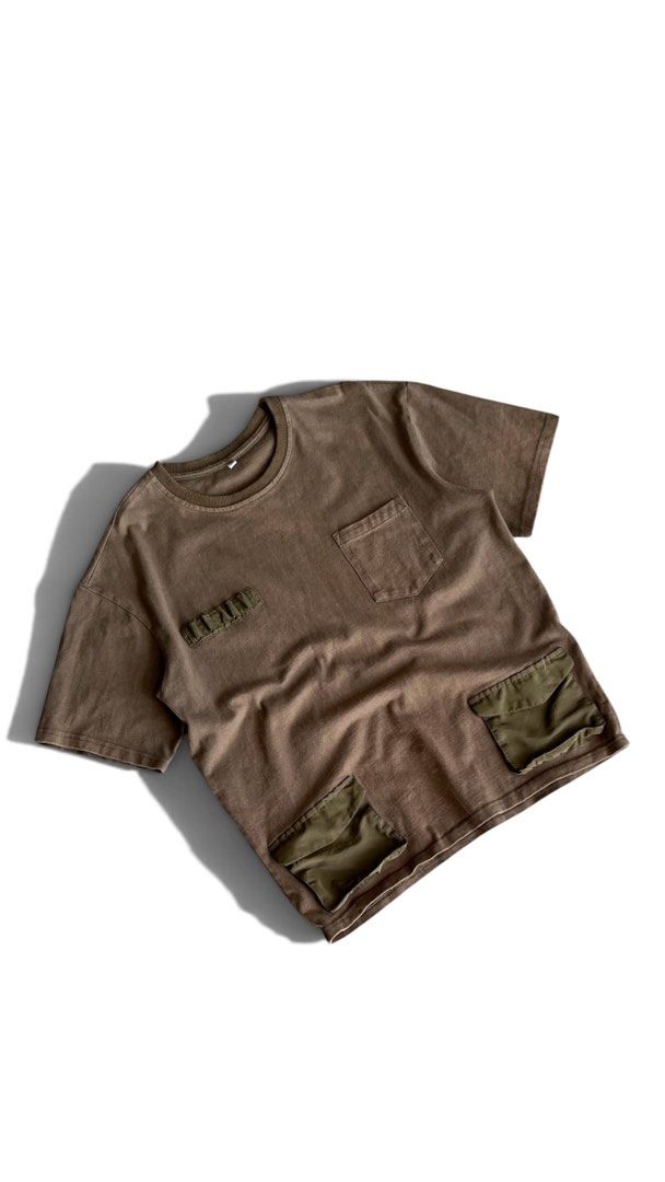 Brown Utility Tee Military Cargo Pockets Size XL (Category: Tshirts & Polo Shirts ) located in Quezon City. Submitted by reluxefinds2025 (Listing ID 1469805728, Image 1). Description: - Size: XL - Color: Brown with olive green nylon details - Style: Tactical cargo streetwear - Features: Chest pocket, small utility loops, and two lower pockets - Material: Heavy cotton with a wash look and relaxed fit - Condition: Clean.