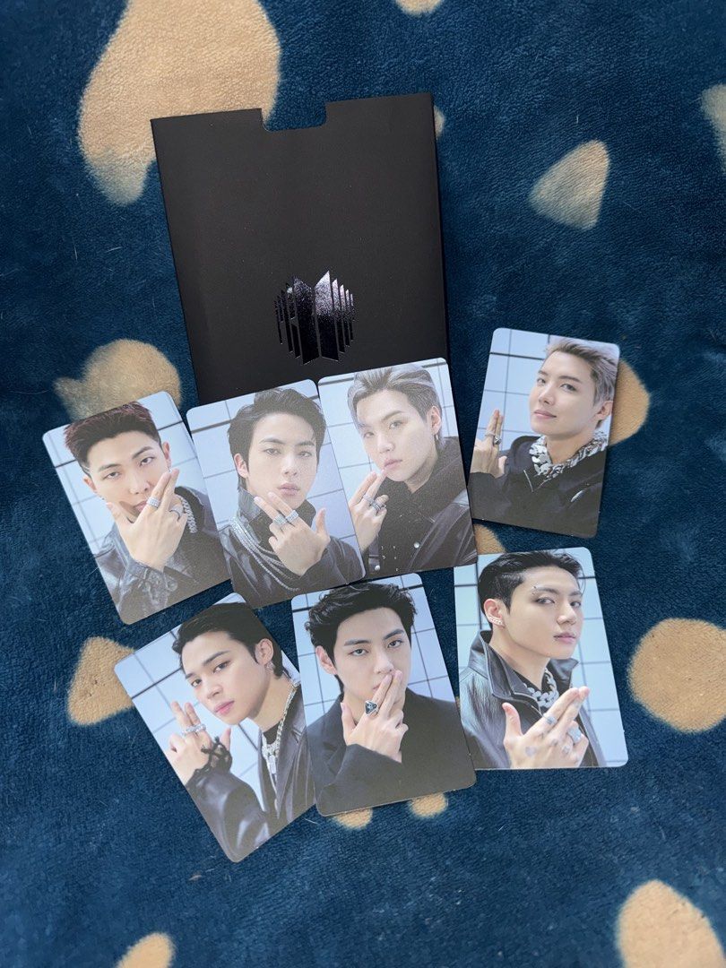 BTS Proof Standard Edition Photocard Set OT7 (Category: K-Wave Merchandise) located in Manila. Submitted by jai.evnglsta (Listing ID 1469785613, Image 2). Description: - Complete OT7 photocard set from BTS Proof Standard Edition - Includes all 7 members: RM, Jin, Suga, J-Hope, Jimin, V, and Jungkook - Comes with the original black folder - Features members with rings against a white tiled background, with silver BTS logo on the back.
