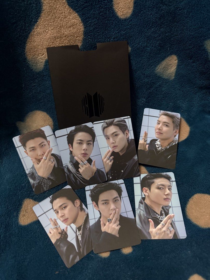BTS Proof Standard Edition Photocard Set OT7 (Category: K-Wave Merchandise) located in Manila. Submitted by jai.evnglsta (Listing ID 1469785613, Image 3). Description: - Complete OT7 photocard set from BTS Proof Standard Edition - Includes all 7 members: RM, Jin, Suga, J-Hope, Jimin, V, and Jungkook - Comes with the original black folder - Features members with rings against a white tiled background, with silver BTS logo on the back.