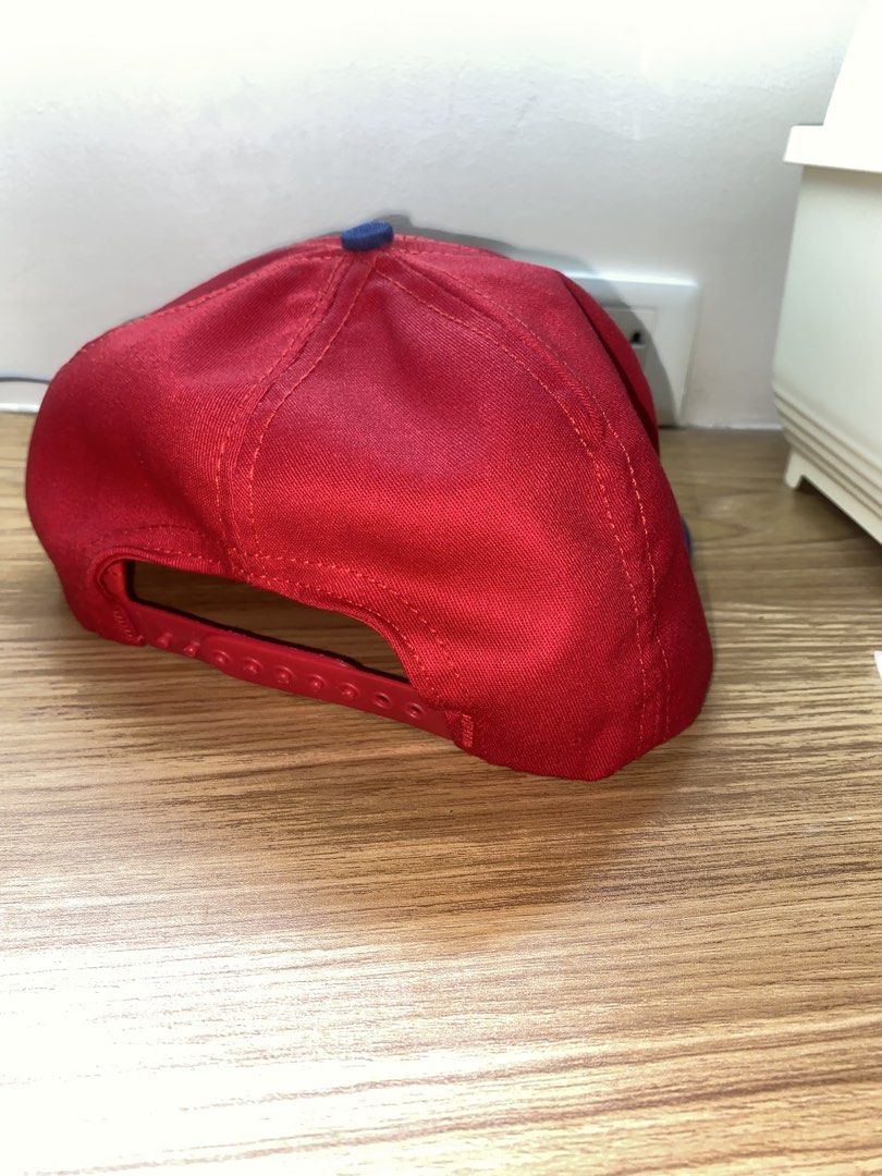 Bud Racing Snapback Cap Red Blue (Category: Caps & Hats) located in Manila. Submitted by brent.0765 (Listing ID 1469817171, Image 3). Description: - Brand: Bud Racing - Style: Snapback Hat - Colors: Red crown with a blue brim - Details: Embroidered Bud Racing logo and checkered flag design on the front - Fit: Adjustable plastic strap closure - Interior: White lining with blue stitching details - Condition: Clean structure, excellent pre-loved con