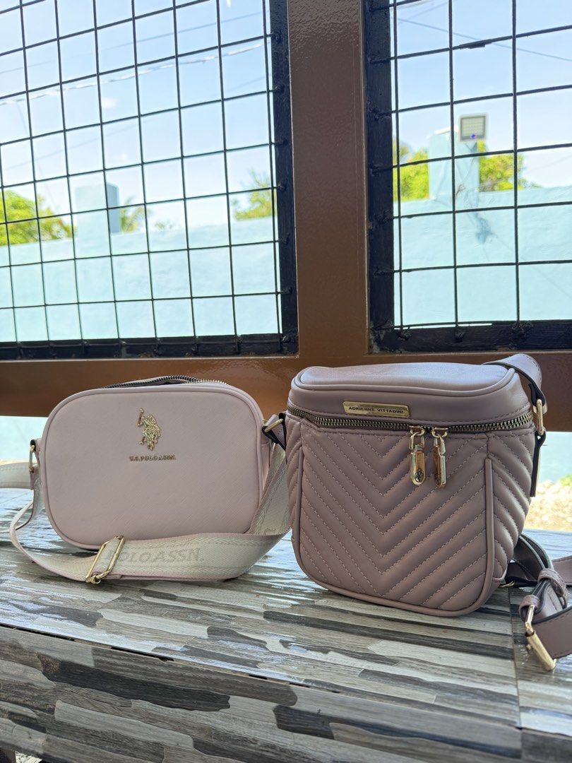 Bundle Sling Bag (Category: Cross-body Bags) located in Munoz. Submitted by shop.holiic (Listing ID 1469807199, Image 1). Description: - 2 stylish crossbody bags available for daily essentials - Option 1: Pink U.S. Polo Assn. camera bag with a wide branded strap and gold hardware - Option 2: Mauve Adrienne Vittadini structured bag with quilted chevron stitching and gold zipper pulls - Both bags feature clean exterior surfaces and hardware finishe