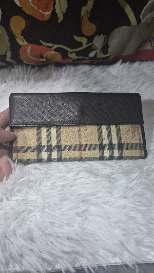 Burberry Check Long Wallet (Category: Luxury Bags & Wallets) located in Baguio. Submitted by jhaz_bags (Listing ID 1469901019, Image 2). Description: Long wallet featuring the classic Burberry check pattern combined with brown leather panels. Snap button closure secures the front flap. Interior includes card slots and compartments with embossed repeating Burberry lettering along the middle fold. Visible wear marks on the check fabric near the top