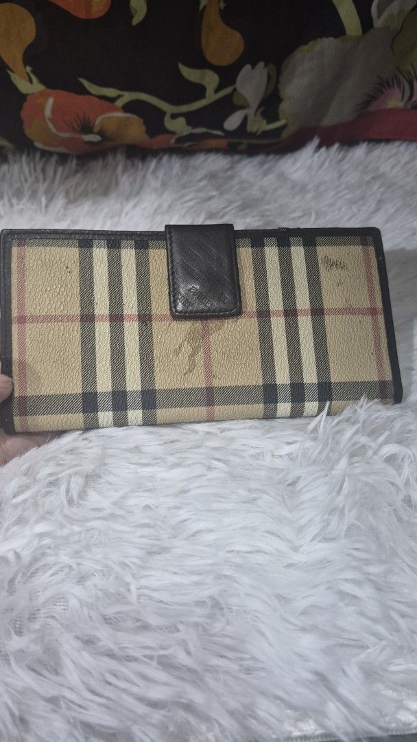 Burberry Check Long Wallet (Category: Luxury Bags & Wallets) located in Baguio. Submitted by jhaz_bags (Listing ID 1469901019, Image 3). Description: Long wallet featuring the classic Burberry check pattern combined with brown leather panels. Snap button closure secures the front flap. Interior includes card slots and compartments with embossed repeating Burberry lettering along the middle fold. Visible wear marks on the check fabric near the top