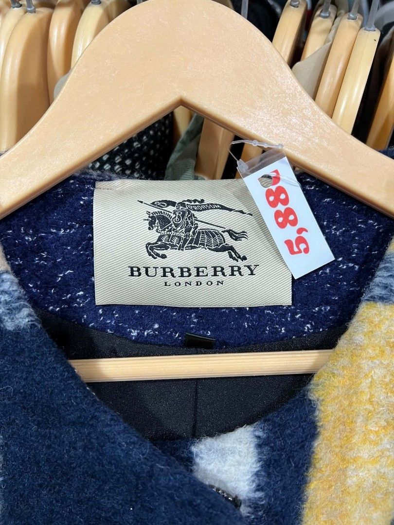 Burberry London Plaid Wool Coat (Category: Luxury Apparel) located in Urdaneta. Submitted by jayceegarage (Listing ID 1469902915, Image 2). Description: - Brand: Burberry London - Style: Chunky textured wool coat - Color/Pattern: Mustard, beige, navy blue, and white plaid - Interior: Fully lined in black with brand label at the collar - Care: Dry clean only - Condition: Excellent pre-loved condition - Perfect statement piece for fall and winter.