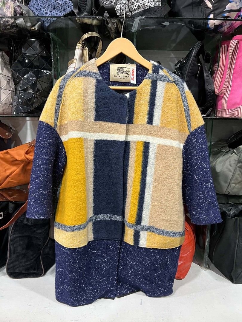 Burberry London Plaid Wool Coat (Category: Luxury Apparel) located in Urdaneta. Submitted by jayceegarage (Listing ID 1469902915, Image 1). Description: - Brand: Burberry London - Style: Chunky textured wool coat - Color/Pattern: Mustard, beige, navy blue, and white plaid - Interior: Fully lined in black with brand label at the collar - Care: Dry clean only - Condition: Excellent pre-loved condition - Perfect statement piece for fall and winter.