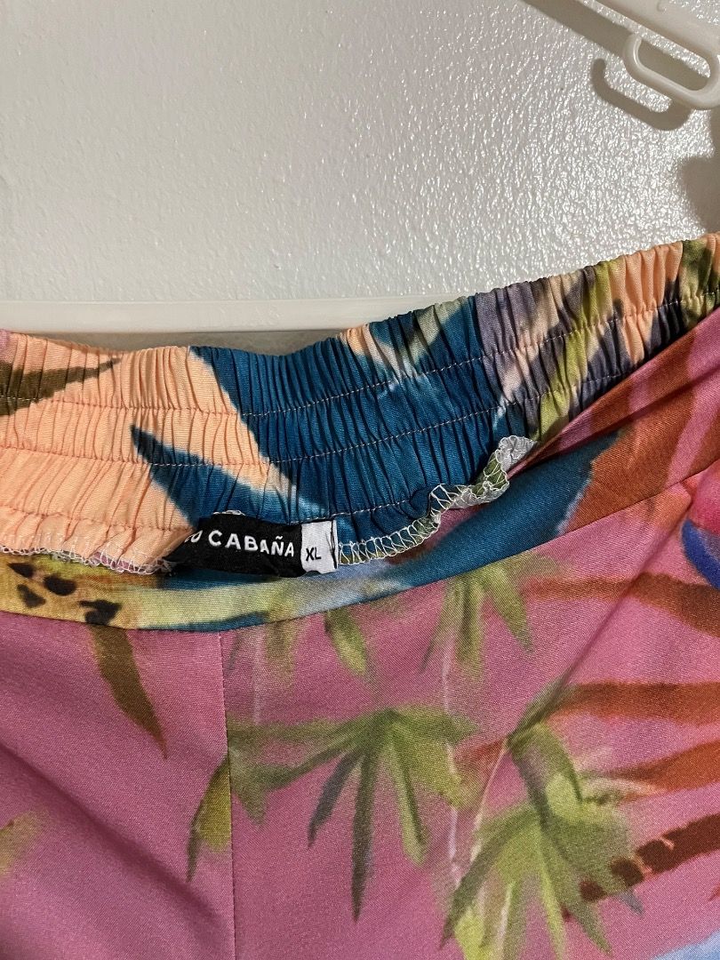 Coco Cabaña Tropical Leopard Print Wide Leg Pants (Category: Jeans) located in Cabuyao City. Submitted by rdtrmt (Listing ID 1469874865, Image 3). Description: - Brand: Cabo Cabaña - Size: XL - Design: Tropical palm tree and leopard print in bright pink, orange, and blue - Fit: Comfortable elastic waistband with a stylish wide-leg style - Fabric: Lightweight and breathable.