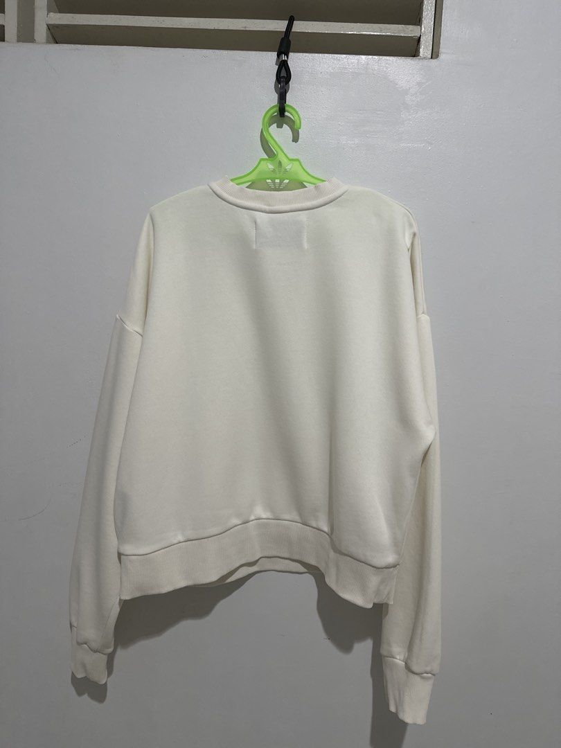 Calvin Klein Textured Sweatshirt (Category: Coats, Jackets and Outerwear) located in Cainta. Submitted by xyzasisa (Listing ID 1469910229, Image 2). Description: - Brand: Calvin Klein - Color: Off-white - Size: US Small / Asia Medium (Chest 80A) - Material: 72% Cotton, 28% Polyester - Design: Large dotted CK logo on front with printed text below - Fit: Drop shoulder, relaxed fit with ribbed collar, cuffs, and hem - Origin: Made in Kenya - Conditi