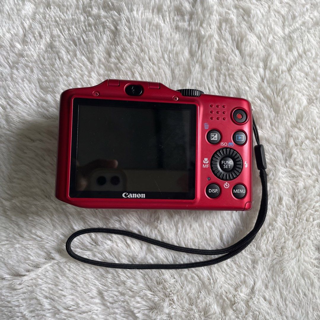 Canon PowerShot SX160 IS Red Digital Camera (Category: Cameras) located in Iloilo. Submitted by sesamhie_ (Listing ID 1469823041, Image 3). Description: - Model: Canon PowerShot SX160 IS (Vibrant Red) - Resolution & Zoom: 16.0 megapixels with 16x optical zoom - Power: Uses standard AA batteries - Included Bundle: 2 x Amazon Basics rechargeable AA batteries and a SanDisk Ultra 16GB SD card - Body: 9/10 (good condition, no visible major scratches) 