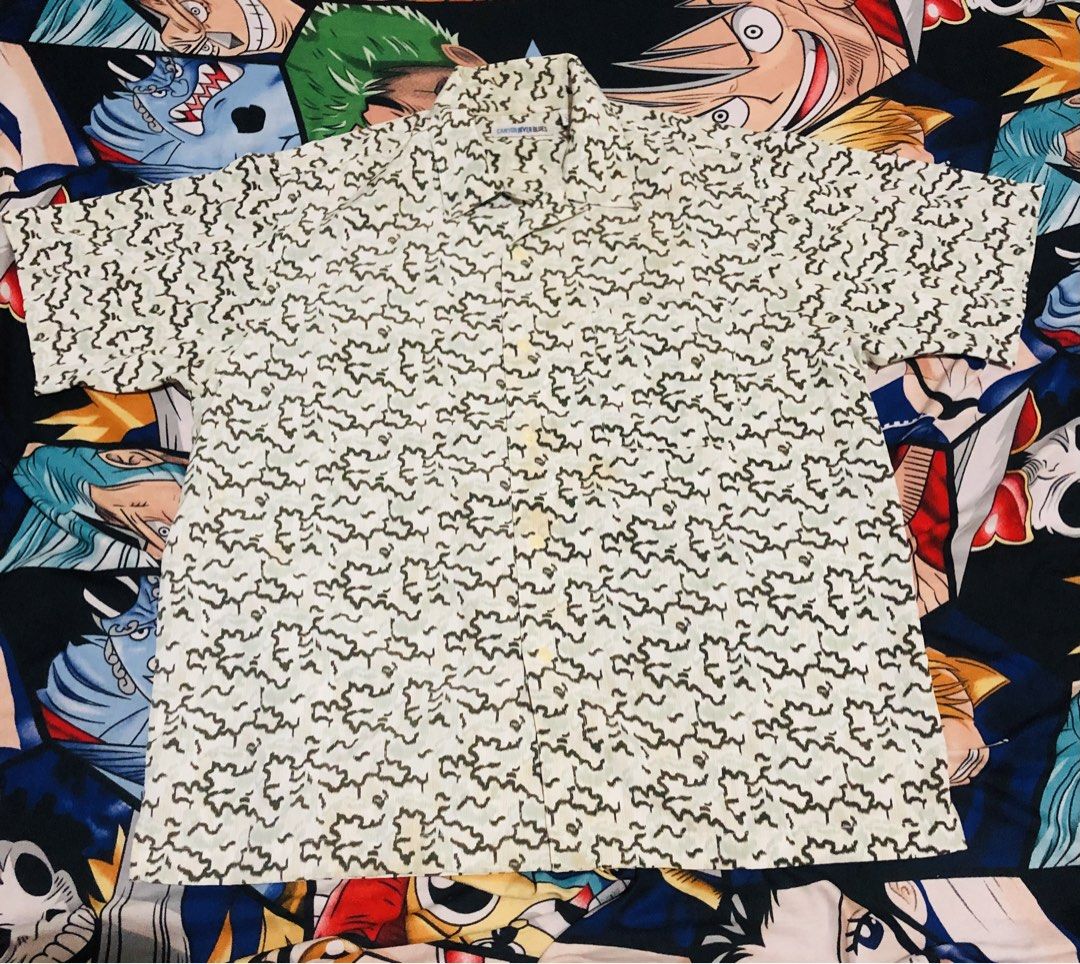 Canyon River Blues Abstract Pattern Short Sleeve Shirt (Category: Tshirts & Polo Shirts ) located in Manila. Submitted by gobvs222 (Listing ID 1469925923, Image 1). Description: Canyon River Blues short sleeve button-up shirt. Size large. Green and off-white abstract pattern all over. Camp collar style with standard front buttons. 100 percent polyester material, lightweight and comfortable. Made in El Salvador. Clean tag inside collar showing bra