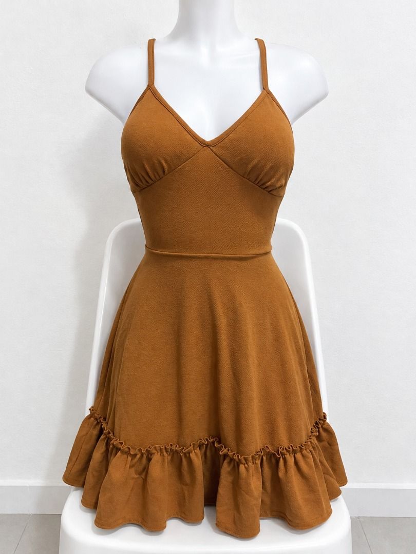 Caramel Brown Cami Mini Dress with Ruffle Hem (Category: Dresses) located in San Jose. Submitted by lerwomensthrift (Listing ID 1469897678, Image 1). Description: Super cute caramel brown mini dress with adjustable spaghetti straps, a v-neck, and an open back with lace-up ties. Features a fitted bodice, elastic back waist, and a flared, ruffled skirt. Lightweight and perfect for sunny days!.