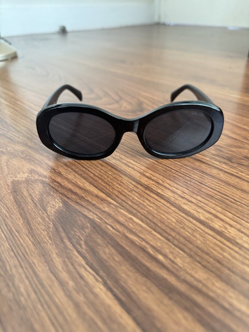 Celine Black Oval Sunglasses Model 6108 (Category: Sunglasses & Eyewear) located in Rizal. Submitted by thrifty.mom (Listing ID 1469860193, Image 1). Description: - Brand: Celine (Made in Italy) - Model: 6108 (52□22-145) - Frame: Black acetate in a chic oval shape - Lenses: Dark tinted with subtle Celine stamp on the right lens - Hardware: Gold-tone Triomphe logo on both temples - Condition: Excellent, clean frames with no scratches on hardware T