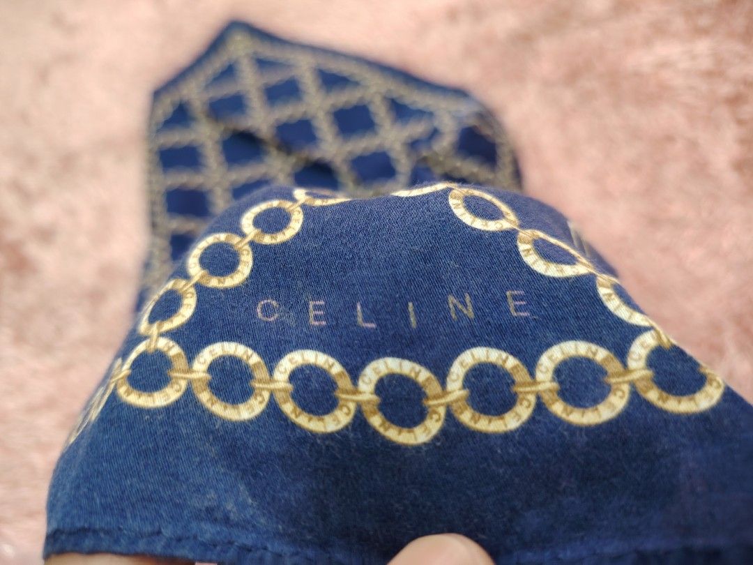 Celine Blue Chain Print Scarf 50x50cm (Category: Other Accessories) located in Valenzuela. Submitted by anna.banana10 (Listing ID 1469786707, Image 2). Description: - Brand: Celine - Design: Blue with gold chain link pattern and integrated logo - Size: 50 x 50 cm (Square) - Material: Smooth, premium fabric - Versatile use: Wear around the neck, tie on a handbag, or style as a hair accessory - Condition: Excellent, well-maintained - Mode of Paymen
