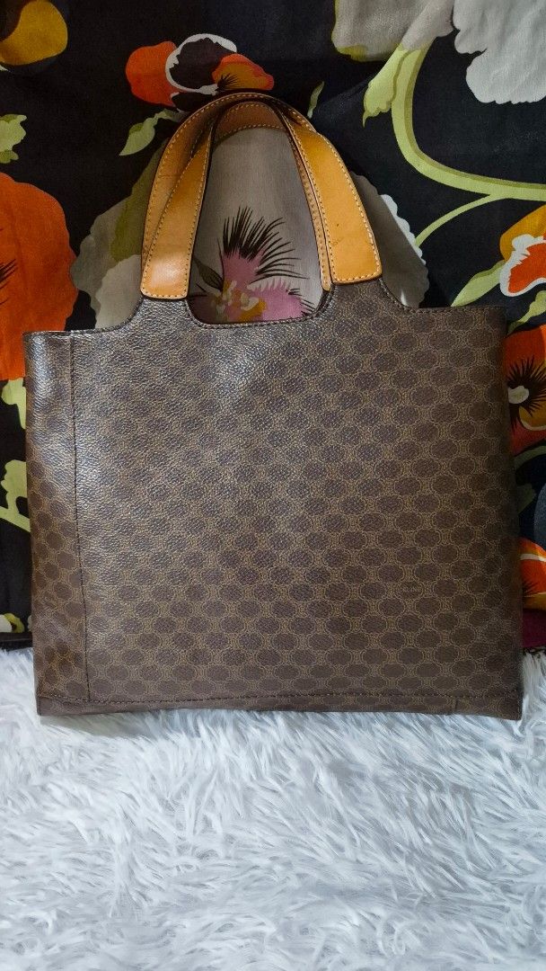 Celine Brown Macadam Monogram Leather Tote Bag (Category: Luxury Bags & Wallets) located in Baguio. Submitted by jhaz_bags (Listing ID 1469934442, Image 3). Description: - Authentic Celine tote in classic brown Macadam monogram coated canvas - Elegant tan leather trim and sturdy dual top handles - Features embossed Celine lettering at the base - Divided interior with a secure center zip compartment - Clean dark brown lining - Perfect everyday siz